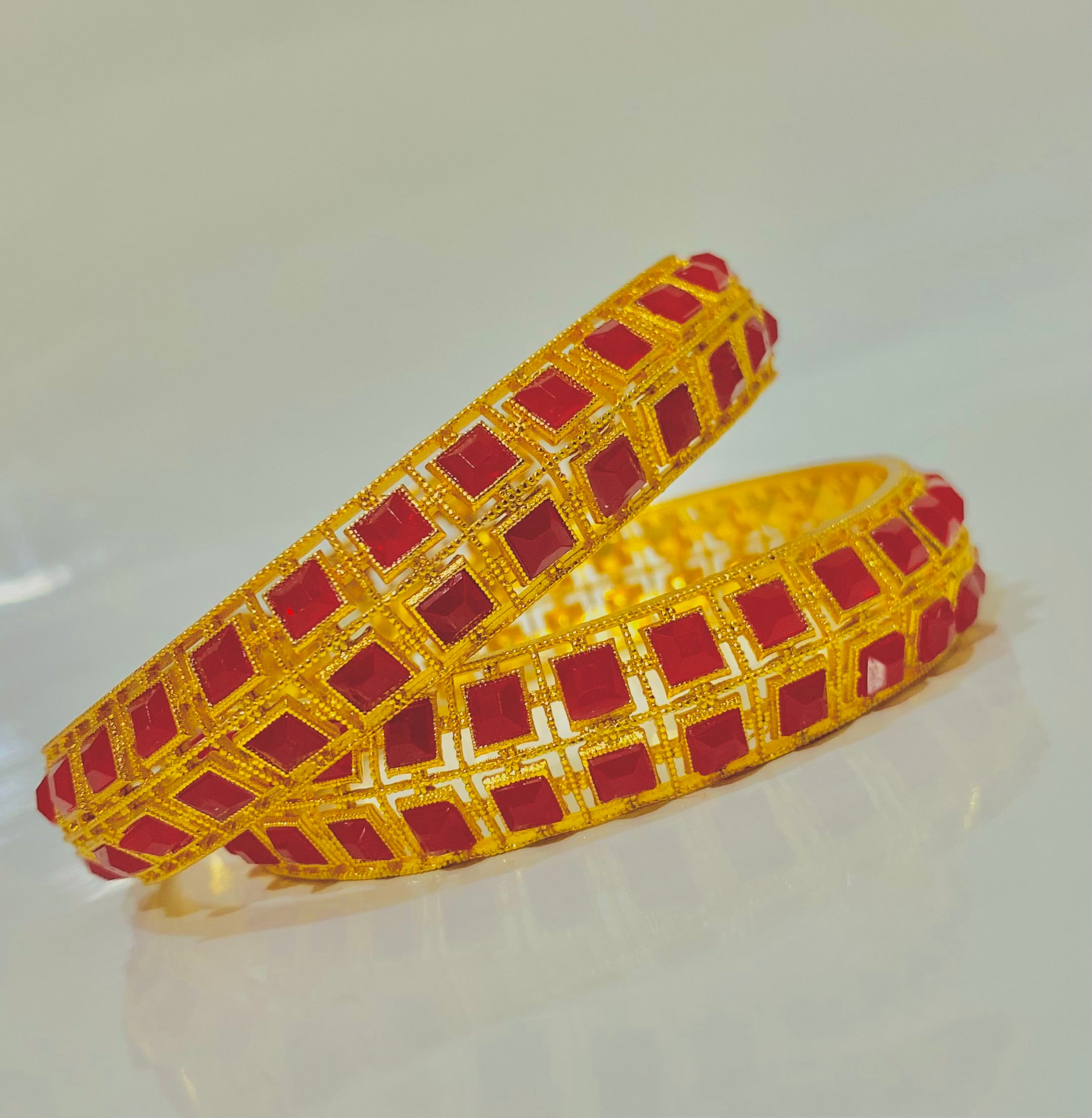 Elegant Gold Bangles with Red Gemstone Accents