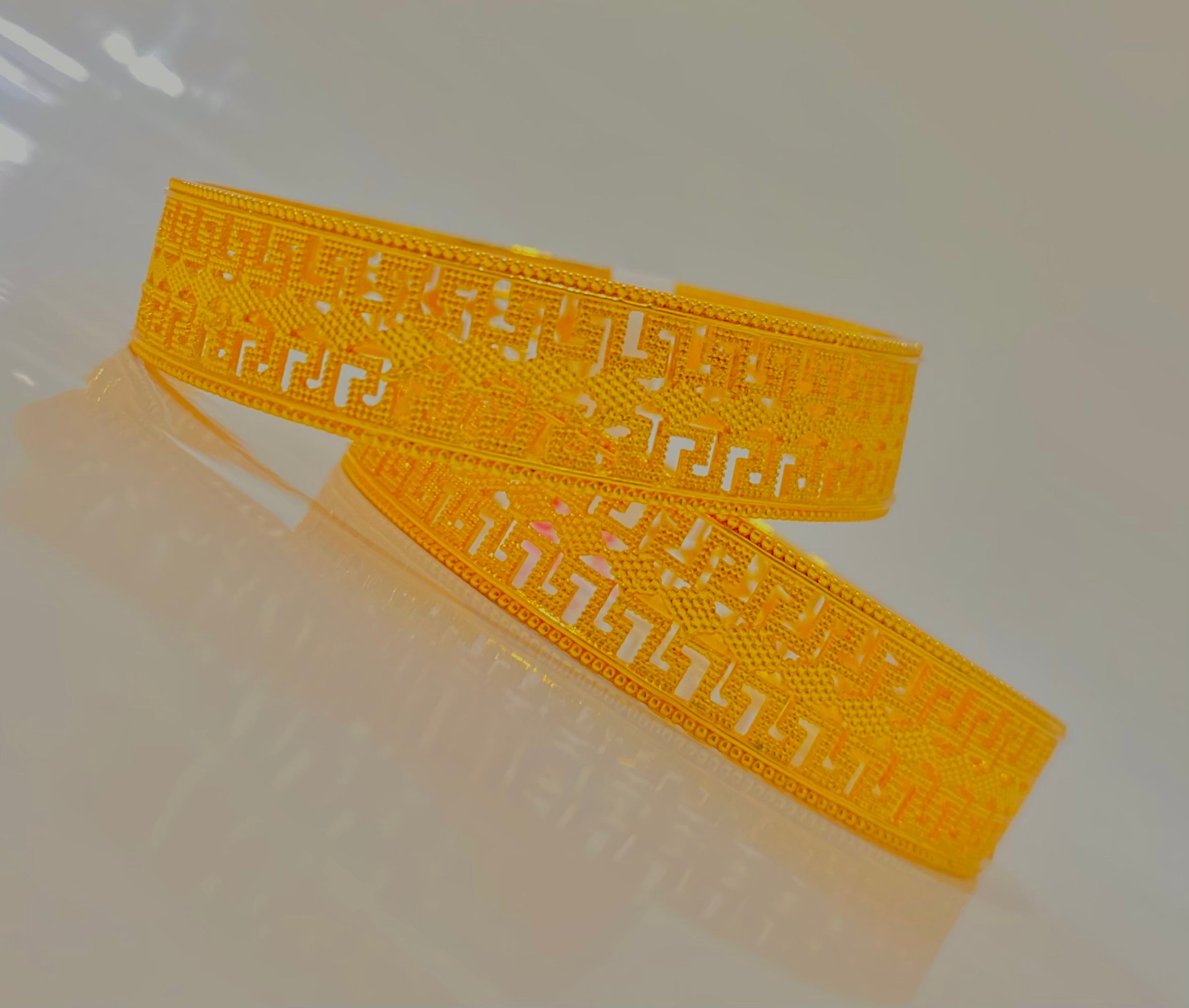 Intricately Designed Gold Bangles with Classic Cut-Out Patterns