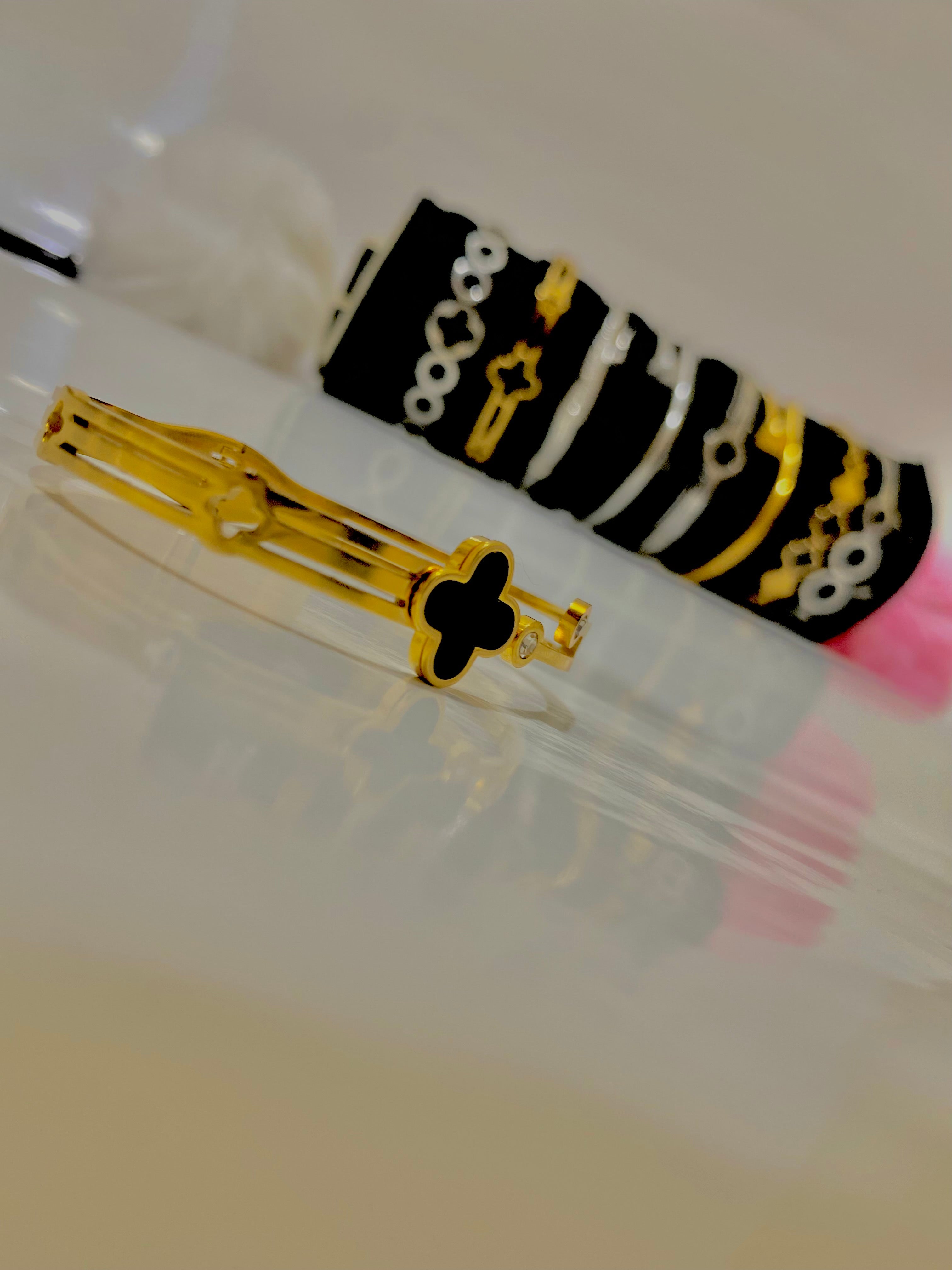 Elegant Gold Bracelet with Diamonds and Black Clover Design