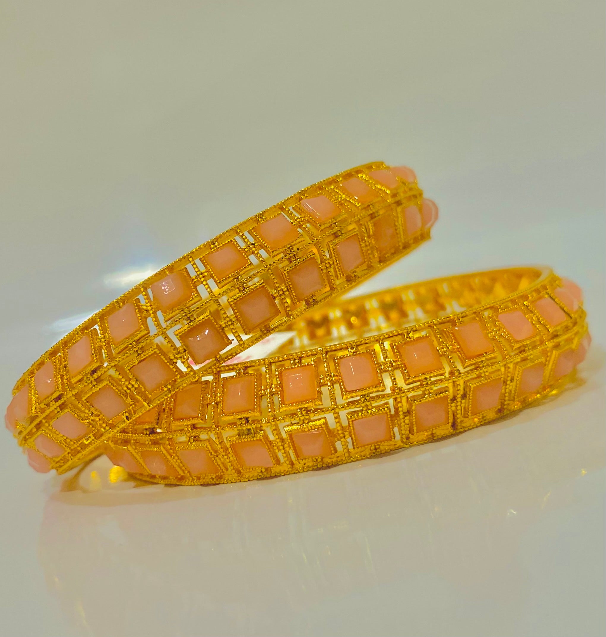 Elegant Gold Bangles with Peach Gemstone Inlays