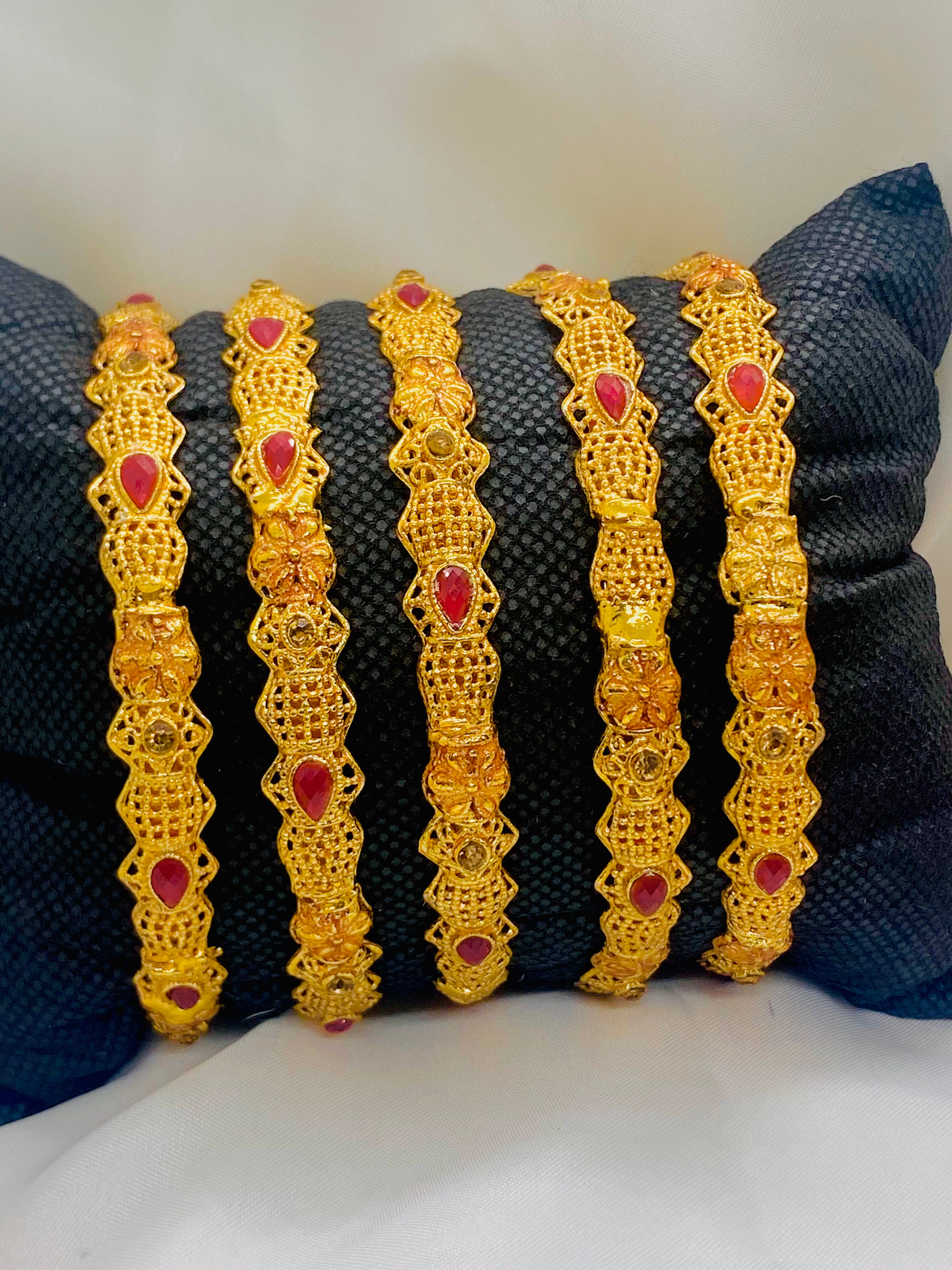 Set of Four Elegant Traditional Gold Bangles with Ruby Red Stones