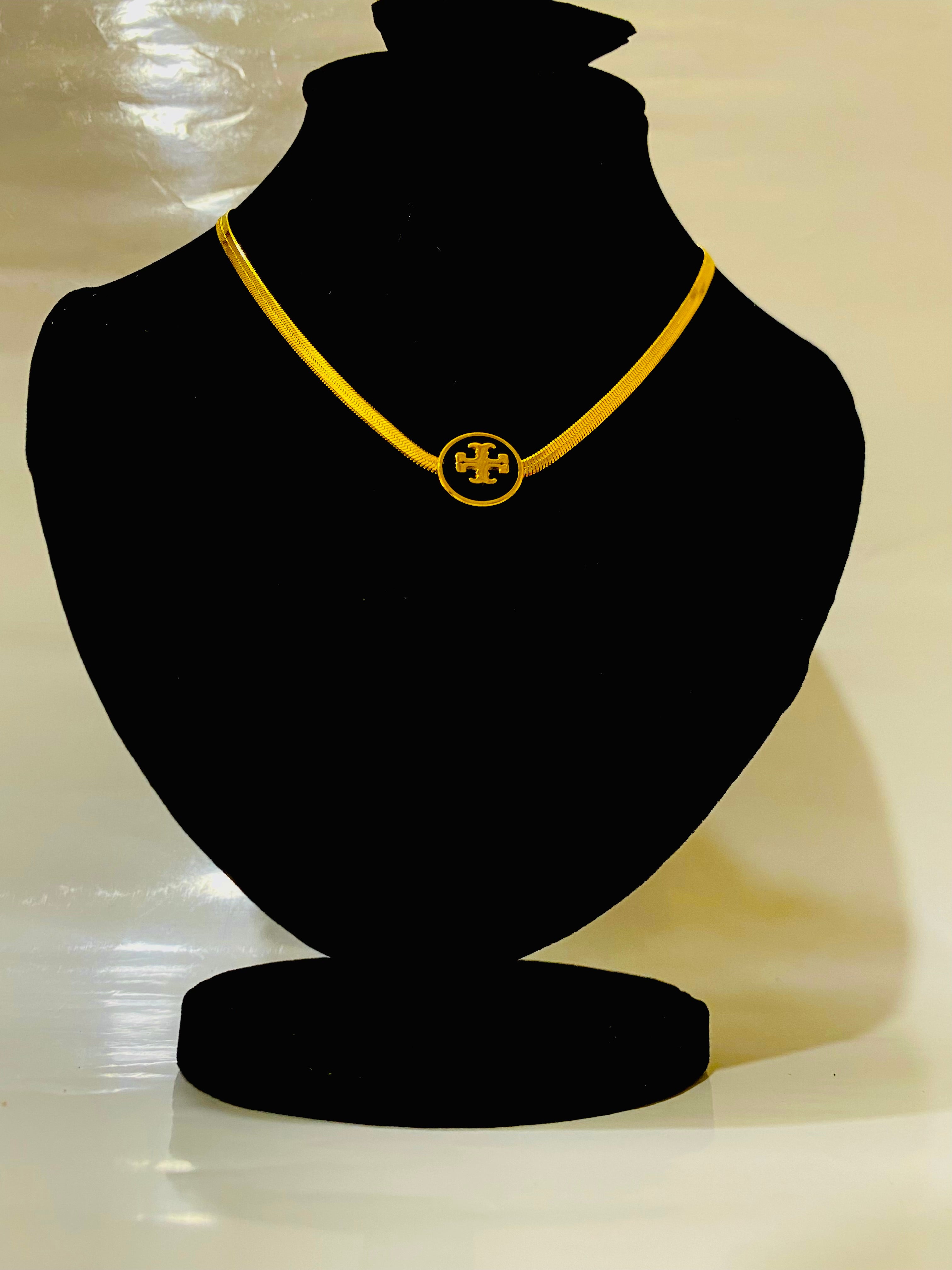 Elegant Gold-Plated Pendant Necklace with Signature Emblem