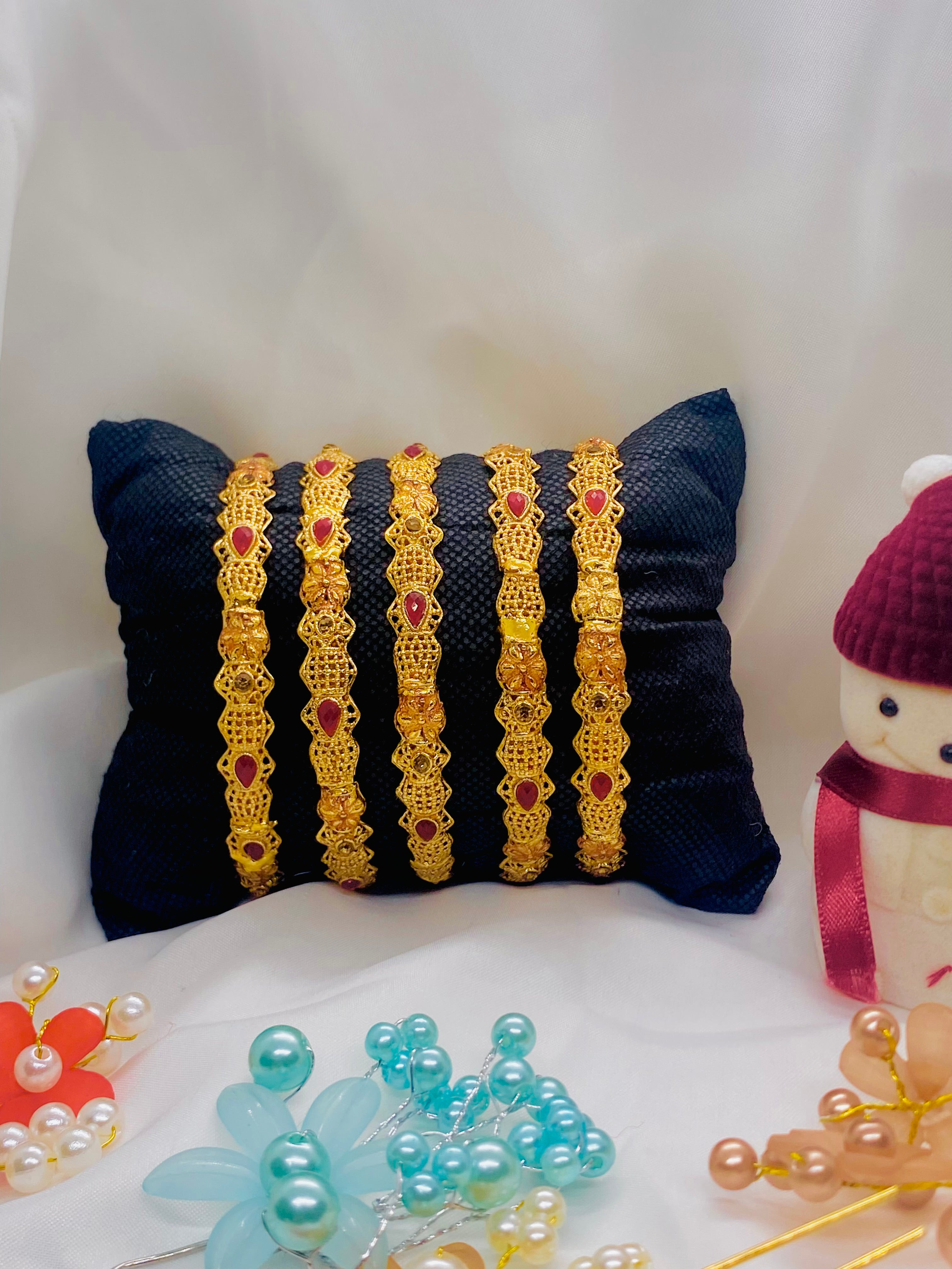 Set of Four Elegant Traditional Gold Bangles with Ruby Red Stones