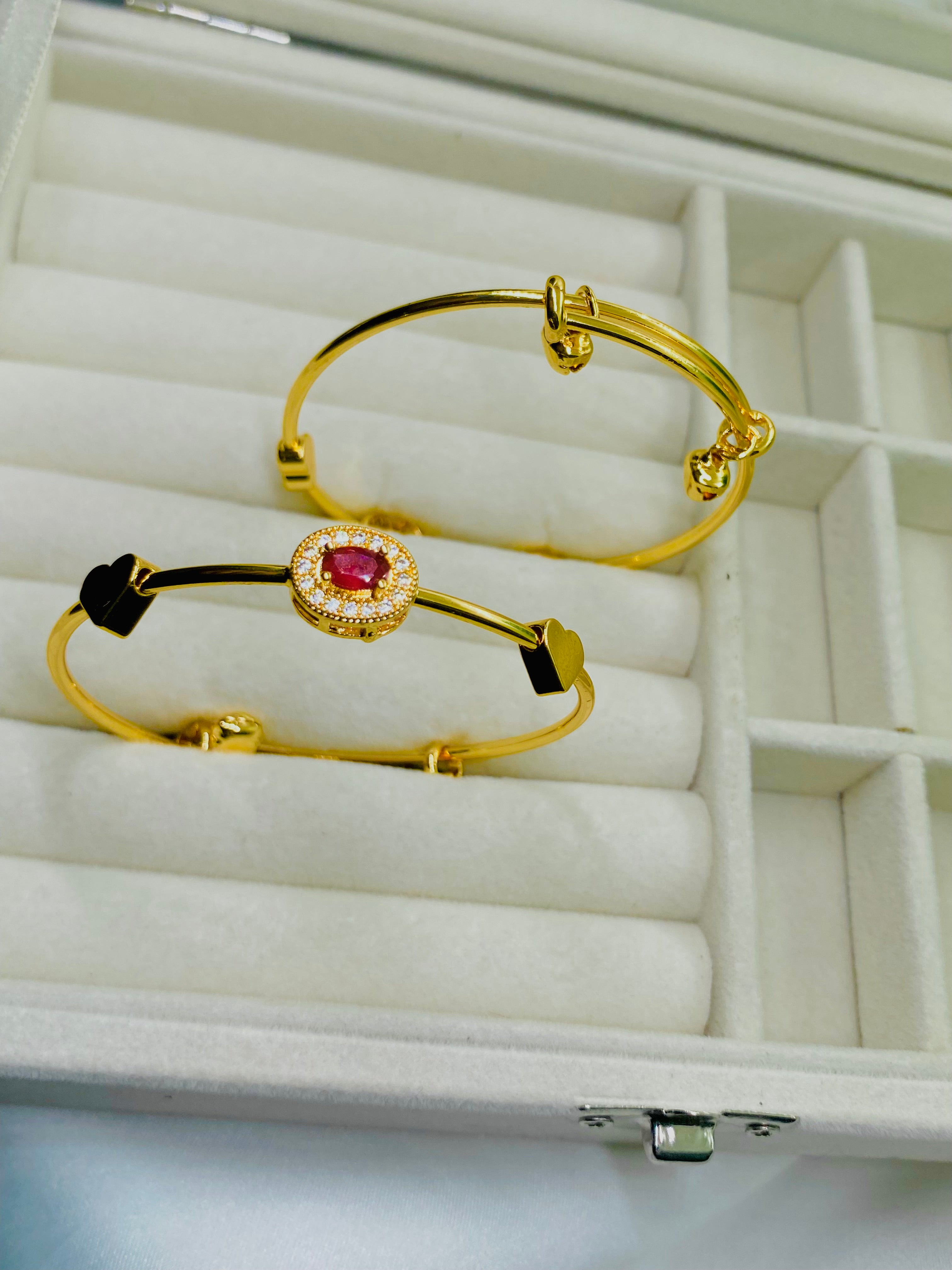 Elegant Gold Bangles with Ruby Accent and Heart Charm