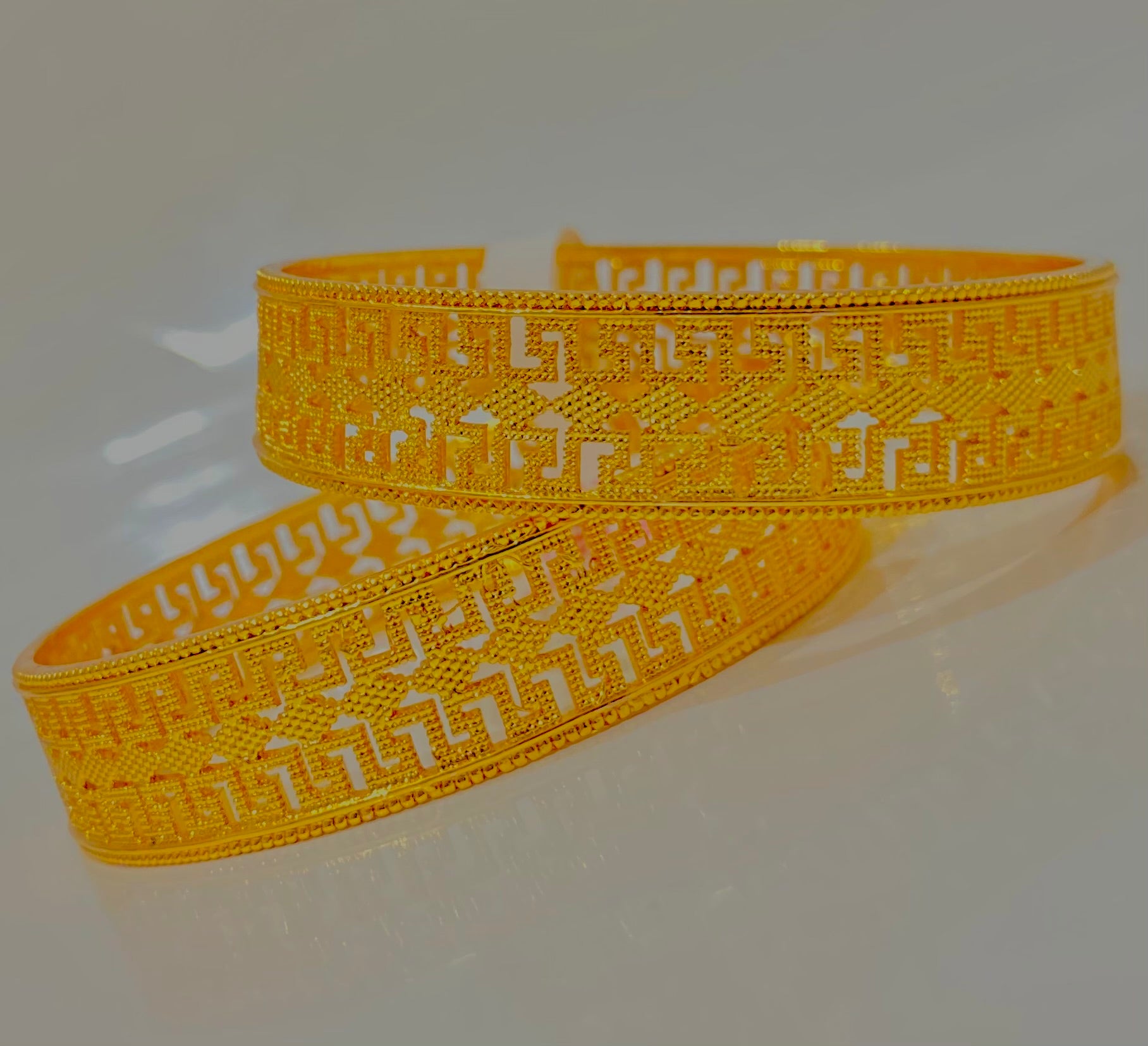 Intricately Designed Gold Bangles with Classic Cut-Out Patterns