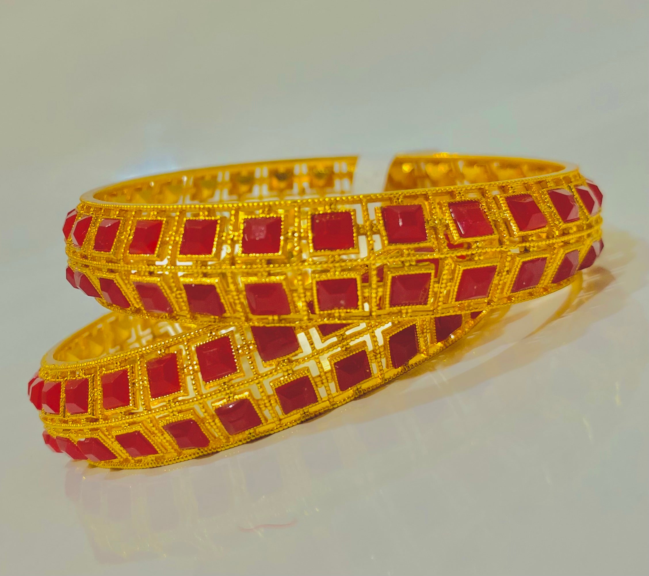 Elegant Gold Bangles with Red Gemstone Accents