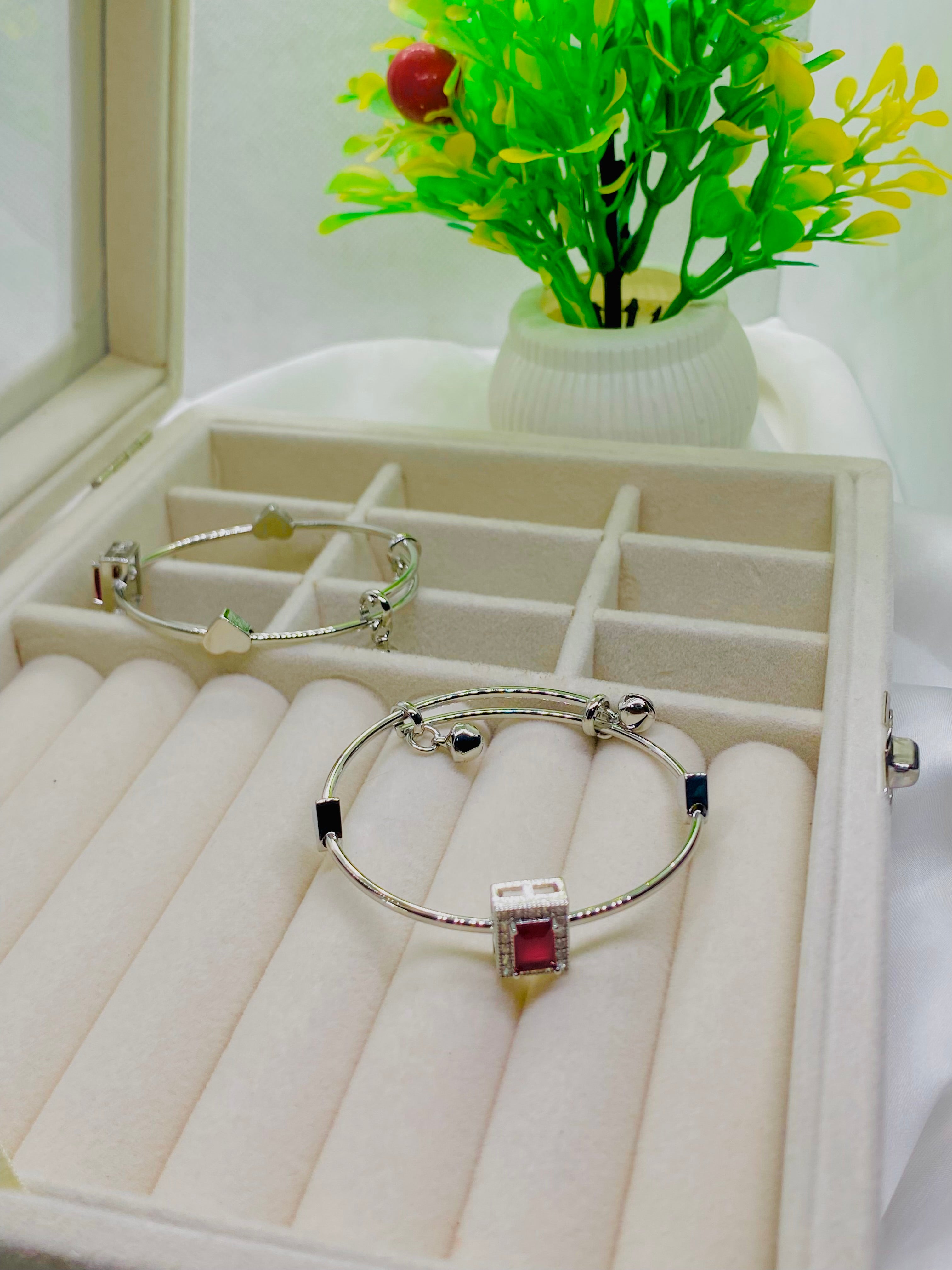 Elegant Silver Charm Bracelet with Red Stone Accent