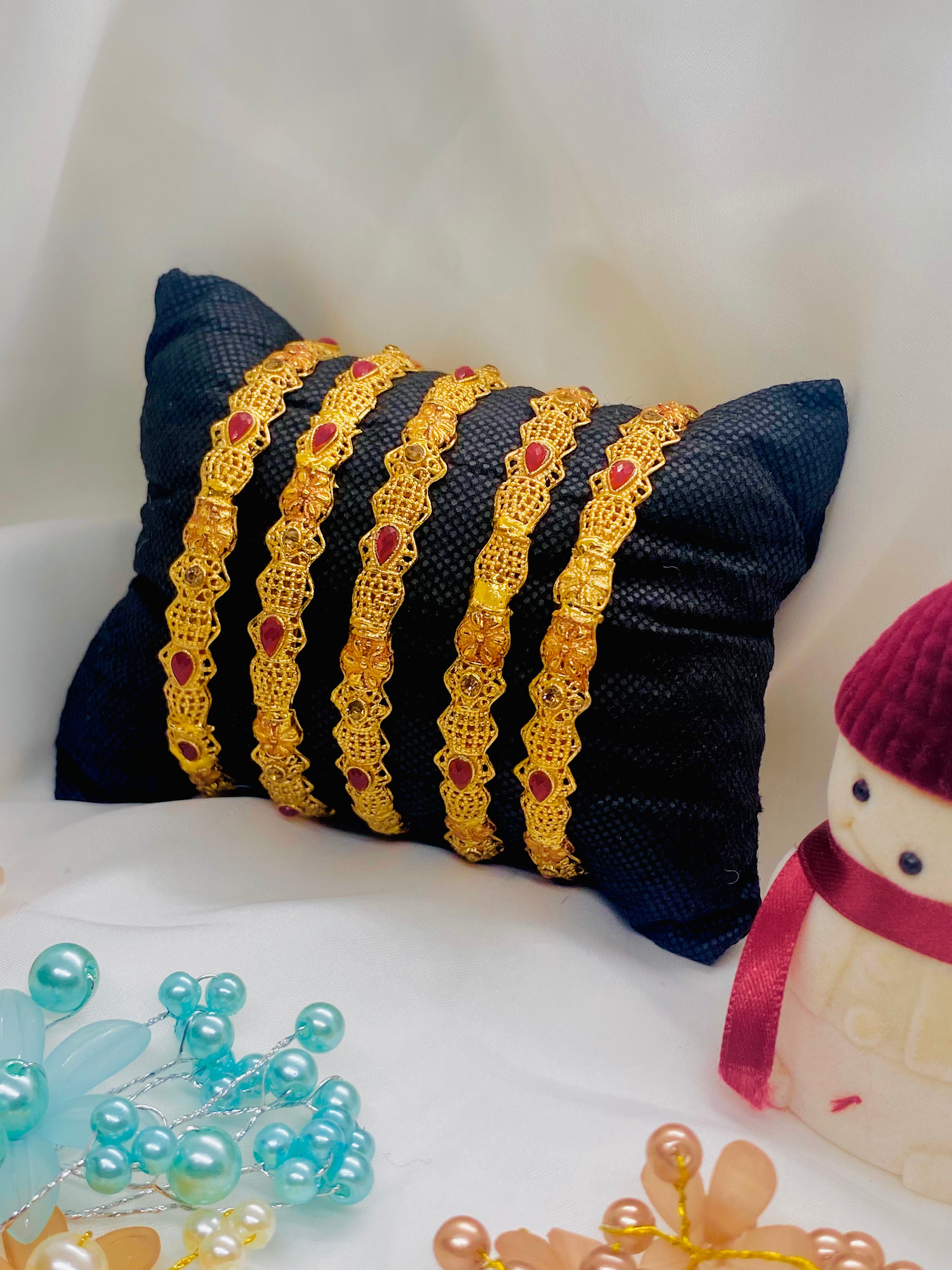 Set of Four Elegant Traditional Gold Bangles with Ruby Red Stones