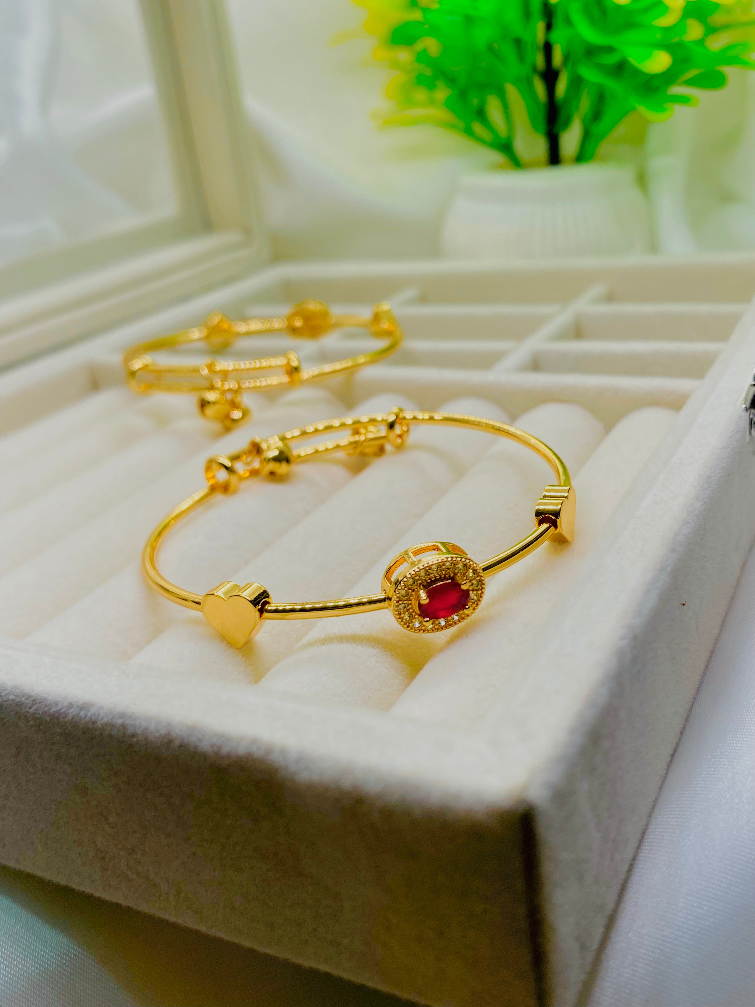Elegant Gold Bangles with Ruby Accent and Heart Charm