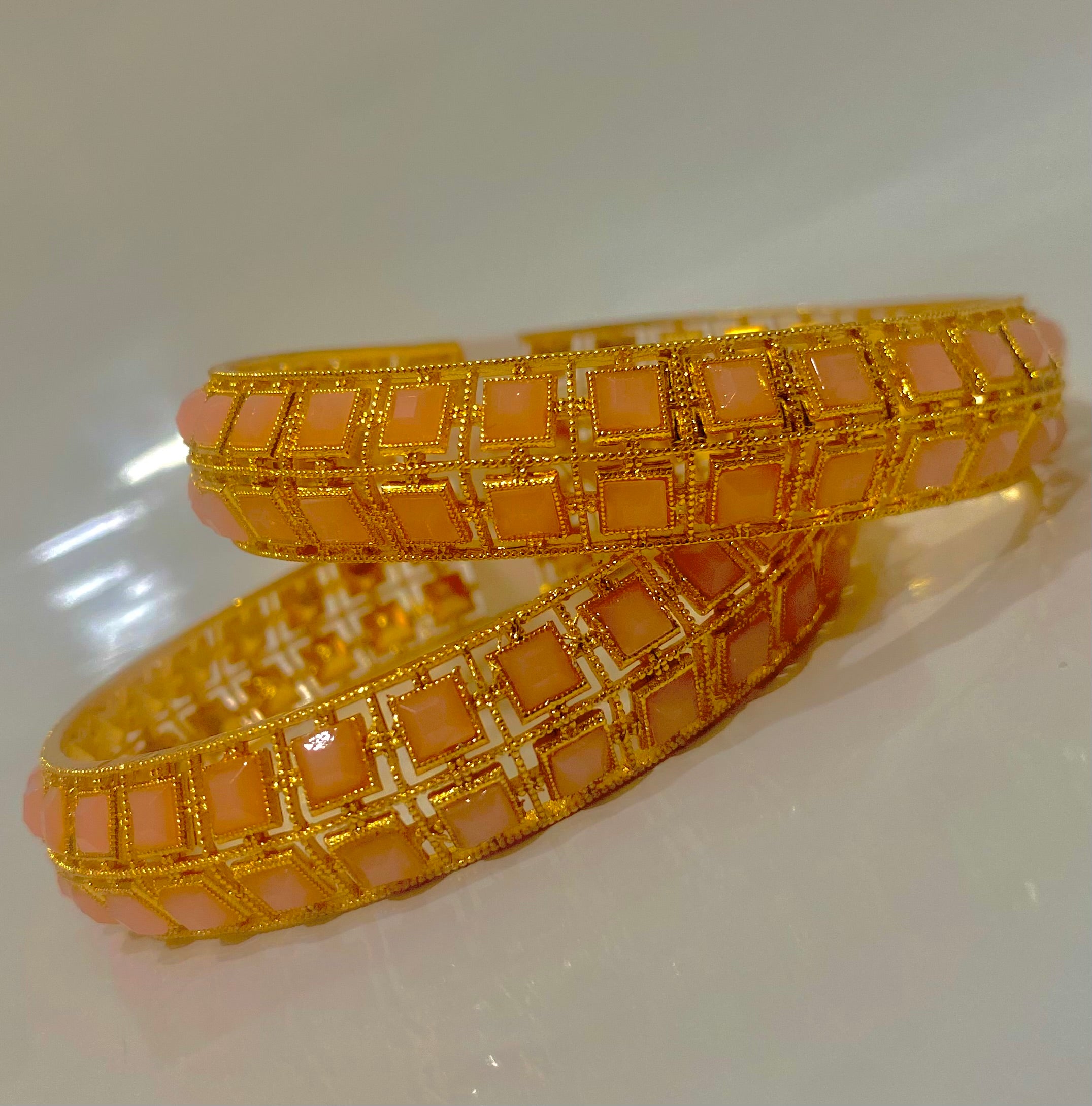 Elegant Gold Bangles with Peach Gemstone Inlays